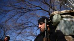 FILE PHOTO: Rebel fighters of Jaysh al-Islam sit at their post in Tal Farzat in the besieged rebel-held eastern Ghouta area of Damascus, Syria February 2, 2017. REUTERS/Bassam Khabieh/File Photo