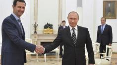 Russian President Vladimir Putin (R) shakes hands with Syrian President Bashar al-Assad during a meeting at the Kremlin in Moscow, Russia, in this October 20, 2015 file photo.  REUTERS/Alexei Druzhinin/RIA Novosti/Kremlin/ Files 