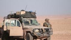 FILE PHOTO: A U.S. fighter stands near a military vehicle, north of Raqqa city, Syria November 6, 2016. REUTERS/Rodi Said