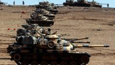 Turkish army tanks take up position on the Turkish-Syrian border near the southeastern town of Suruc in Sanliurfa province October 6, 2014. REUTERS/Umit Bektas 