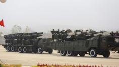 FILE PHOTO: Soldiers ride military vehicles during a parade to mark the 70th anniversary of Armed Forces Day in Myanmar's capital Naypyitaw