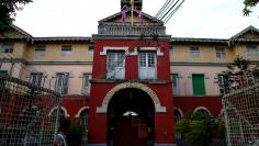 A security officer stands guard in front of Insein Prison in Yangon