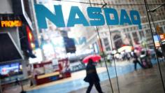 Pedestrians walk past the NASDAQ MarketSite in New York's Times Square in this June 4, 2012 file photo. REUTERS/Eric Thayer/Files