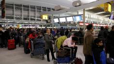 Passengers line up to check-in at the departures area of Terminal 4 at John F. Kennedy International Airport in New York City, U.S. January 7, 2018.  REUTERS/Andrew Kelly