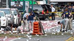 Federal Bureau of Investigation (FBI) and other security officials mark evidence near the site of an explosion which took place on Saturday night in the Chelsea neighborhood of Manhattan, New York, U.S.  September 18, 2016.  REUTERS/Rashid Umar Abbasi