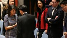 U.S. Ambassador to the United Nations Nikki Haley (L) speaks with Chinese Deputy Ambassador to the United Nations Wu Haitao (R) ahead of the United Nations Security Council session on imposing new sanctions on North Korea, in New York, U.S., December 22,