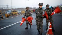 South Korean soldiers place traffic cones at a checkpoint on the Grand Unification Bridge in Paju