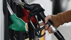 A customer prepares to fill up his tank in a gasoline station in Nice December 5, 2014. REUTERS/Eric Gaillard