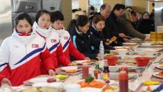 North and South Korea women's ice hockey athletes stand in a line at a dining hall at the Jincheon National Training Centre in Jincheon, South Korea January 25, 2018. The Ministry of Culture, Sports and Tourism/Yonhap via REUTERS     