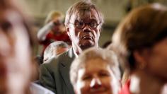 FILE PHOTO: Author and radio personality, Keillor, listens to U.S. President Barack Obama speak at a campaign rally in Minneapolis