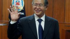 FILE PHOTO -  Peru's former President Alberto Fujimori waves as he enters the courtroom before his trial at the Special Police Headquarters in Lima