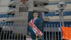 A picture of Peru's former President Alberto Fujimori who was serving a 25-year prison sentence is seen outside Centenario hospital after President Pedro Pablo Kuczynski pardoned him, in Lima, Peru, December 25, 2017.  The sign reads: "Lord have mercy an