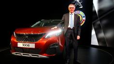 FILE PHOTO: Carlos Tavares, CEO of PSA Peugeot Citroen, poses with the Car of the Year Peugeot 3008 during the 87th International Motor Show at Palexpo in Geneva, Switzerland, March 7, 2017. REUTERS/Arnd Wiegmann /File Photo