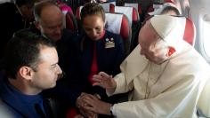 Pope Francis celebrates the marriage of crew members Paula Podest and Carlos Ciufffardi during the flight between Santiago and the northern city of Iquique