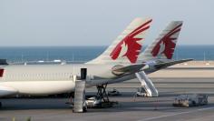 FILE PHOTO: Qatar Airways aircraft at Hamad International Airport in Doha, Qatar June 12, 2017. REUTERS/Naseem Zeitoon/File Photo 