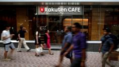 FILE PHOTO: Pedestrians walk past a Rakuten Cafe at a shopping district in Tokyo August 4, 2014.  REUTERS/Yuya Shino/File Photo