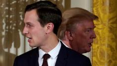 FILE PHOTO: U.S. President Donald Trump passes his adviser and son-in-law Jared Kushner during a Hanukkah Reception at the White House in Washington, U.S., December 7, 2017.  REUTERS/Kevin Lamarque