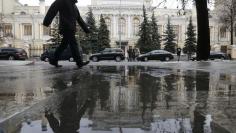 FILE PHOTO: A man walks near the Central Bank headquarters in central Moscow, Russia January 29, 2016. REUTERS/Maxim Zmeyev/File Photo 