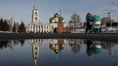 A woman pushes a pram near the Kremlin in Tula, south of Moscow, Russia January 26, 2018. REUTERS/Maxim Shemetov 