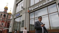 People walk past a branch of Promsvyazbank in Moscow