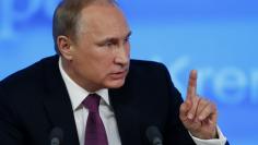 Russian President Vladimir Putin gestures during his annual end-of-year news conference in Moscow December 18, 2014. REUTERS/Maxim Zmeyev 