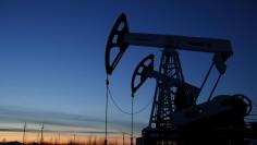 Pump jacks are seen at the Lukoil company owned Imilorskoye oil field outside the West Siberian city of Kogalym