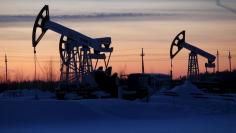 Pump jacks are seen at the Lukoil company owned Imilorskoye oil field, as the sun sets, outside the West Siberian city of Kogalym, Russia, January 25, 2016. REUTERS/Sergei Karpukhin 