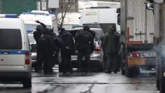 Members of law enforcement services gather after a gunman opened a fire in the pastry-making factory "Menshevik" in Moscow