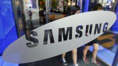 FILE PHOTO: Students walk out of a showroom at the headquarters of Samsung Electronics in Seoul October 28, 2011. REUTERS/Jo Yong-Hak