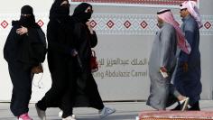 People walk during King Abdulaziz Camel Festival in Rimah Governorate, north-east of Riyadh