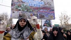 An Iranian protester holds a placard with the picture of Shi'ite cleric Sheikh Nimr al-Nimr (top L), who was executed in Saudi Arabia, during a rally after Friday prayers in Tehran January 8, 2016. REUTERS/Raheb Homavandi/TIMA 