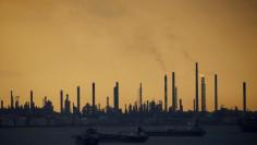 FILE PHOTO: Storm clouds gather over Shell's Pulau Bukom oil refinery in Singapore