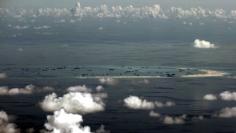 FILE PHOTO: An aerial photo taken though a glass window of a Philippine military plane shows the alleged on-going land reclamation by China on Mischief Reef in the Spratly Islands in the South China Sea, west of Palawan, Philippines, May 11, 2015.  REUTE