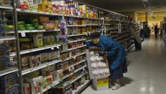 A woman looks for supplies at a Waldbaums grocery store in Long Beach, New York November 2, 2012. REUTERS/Shannon Stapleton