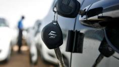 FILE PHOTO: Keys hang from door of Maruti Suzuki Swift car at its stockyard on the outskirts of the western Indian city of Ahmedabad