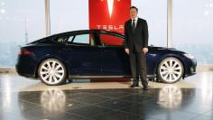 Tesla Motors Inc Chief Executive Elon Musk poses with a Tesla Model S electric car in Tokyo September 8, 2014.   REUTERS/Toru Hanai 