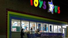 FILE PHOTO: Consumers leave a Toys R Us store with full shopping carts after shopping on the day dubbed "Black Friday" in Framingham