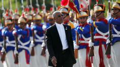 Guyana's President David Arthur Granger review an honour guard during Mercosur trade bloc annual summit in Brasilia