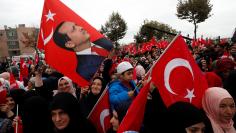 FILE PHOTO: Supporters of Turkish President Erdogan wave flags during the opening ceremony of Recep Tayyip Erdogan Imam Hatip School in Istanbul,