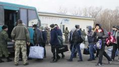 Prisoners of war from the self-proclaimed Luhansk People's Republic board a bus during the exchange of captives in Donetsk region