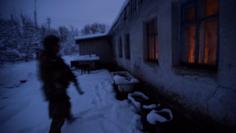 A member of the Ukrainian armed forces patrols area in the government-held village of Travneve, Ukraine, November 23, 2017. Picture taken November 23, 2017.  REUTERS/Oleksandr Klymenko