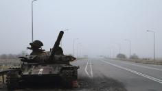 A destroyed tank is seen along a road on the territory controlled by the self-proclaimed Luhansk People's Republic near airport of Luhansk, in Luhansk region, eastern Ukraine, November 19, 2014. REUTERS/Antonio Bronic