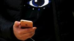 A customer holds an iPhone 6s during the official launch at the Apple store in central Sydney, Australia