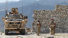 U.S. soldiers stand guard near the site of a U.S. bombing in the Achin district of Nangarhar province in eastern Afghanistan April 15, 2017. REUTERS/Parwiz 