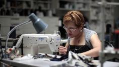 Worker Maria Robles sews clothes at the Karen Kane clothing company in Los Angeles, California June 30, 2011.   REUTERS/Lucy Nicholson  