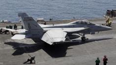 A F/A-18E/F Super Hornets of Strike Fighter Attack Squadron 211 (VFA-211) is lined up for take off on the flight deck of the USS Theodore Roosevelt (CVN-71) aircraft carrier in the Gulf June 18, 2015. REUTERS/Hamad I Mohammed/File Photo 