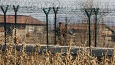 North Korean soldiers patrol behind a border fence near the North Korean town of Sinuiju, March 31, 2017.  REUTERS/Damir Sagolj