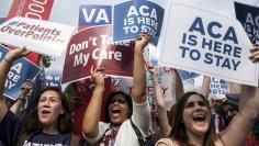 Supporters of the Affordable Care Act celebrate after the Supreme Court up held the law in the 6-3 vote at the Supreme Court in Washington June 25, 2015.  REUTERS/Joshua Roberts 