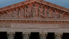 FILE PHOTO: The top of U.S. Supreme Court building is lit at dusk in Washington