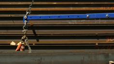 FILE PHOTO - A worker guides a steel beam into place at a construction site in San Francisco, California September 1, 2011. REUTERS/Robert Galbraith  